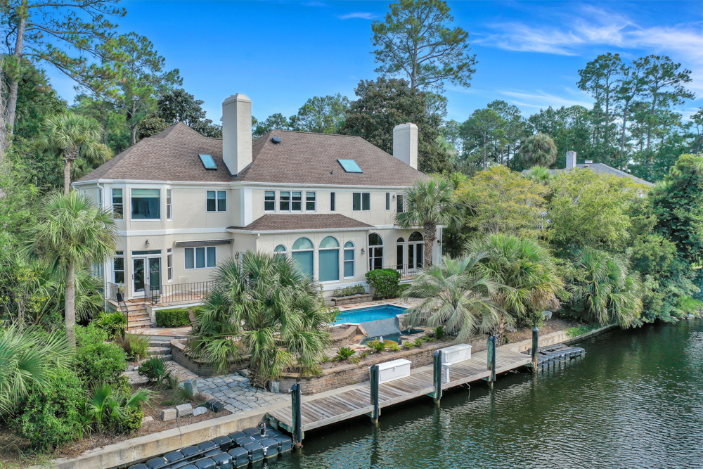 real estate photography of the front view of a beautiful Georgia waterfront home with a pool.