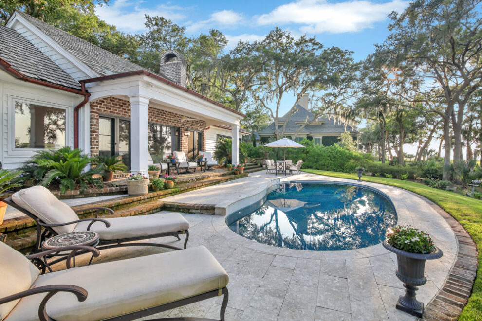 Charleston real estate photography of a cute mini pool with lounge area.